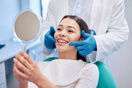 Happy patient checking her smile